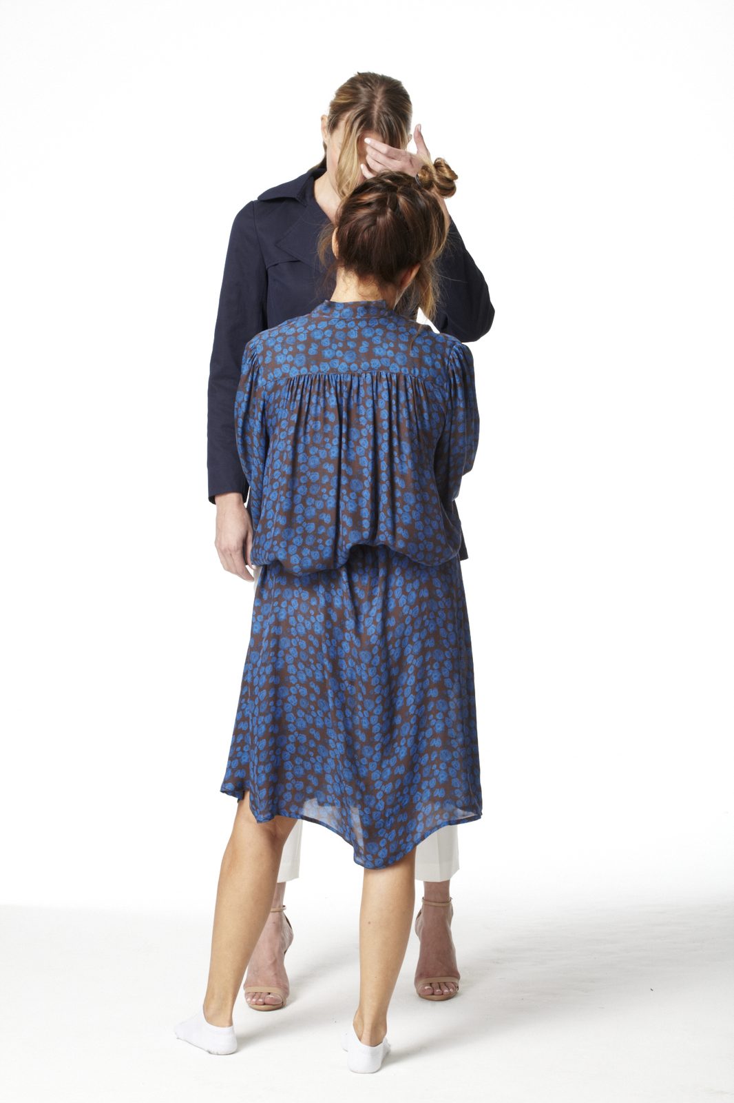 Nancy Berger adjusting a look during a fashion photoshoot